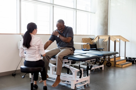 Injured senior man is examined by a doctor in a medical facility